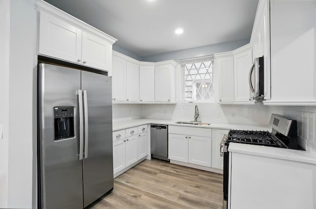 517 S Champion Ave, Columbus, OH 43205 - kitchen with appliances with stainless steel finishes, a sink, white cabinets, decorative backsplash, and recessed lighting