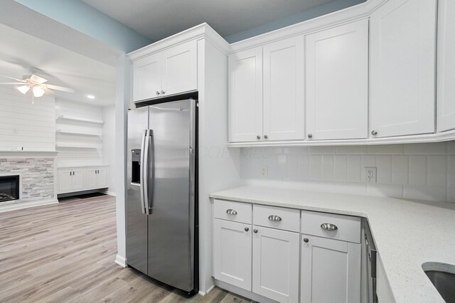 517 S Champion Ave, Columbus, OH 43205 - kitchen featuring stainless steel refrigerator with ice dispenser, a ceiling fan, white cabinets, tasteful backsplash, and light wood-type flooring