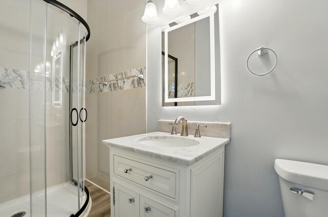 517 S Champion Ave, Columbus, OH 43205 - full bath with toilet, a shower stall, vanity, and wood finished floors