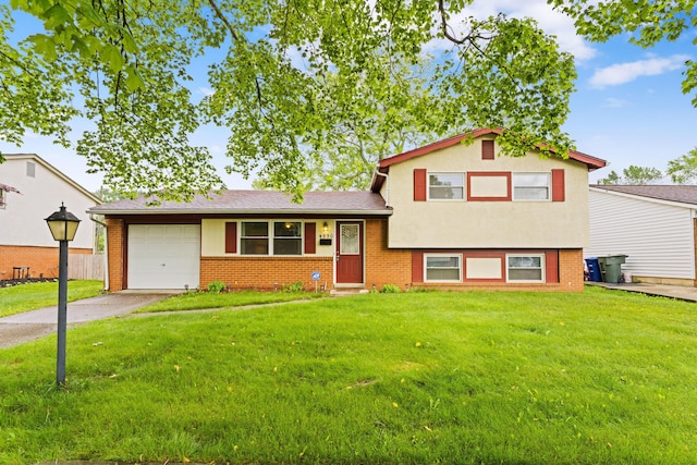 4930 Carbondale Dr, Columbus, OH 43232 - tri-level home with a garage, concrete driveway, a front lawn, and brick siding