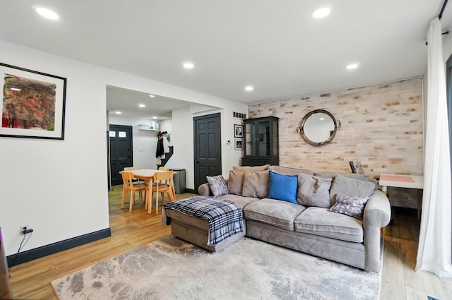 538 S Otterbein Ave Unit 2E, Westerville, OH 43081 - living room with brick wall, wood finished floors, baseboards, recessed lighting, and an accent wall