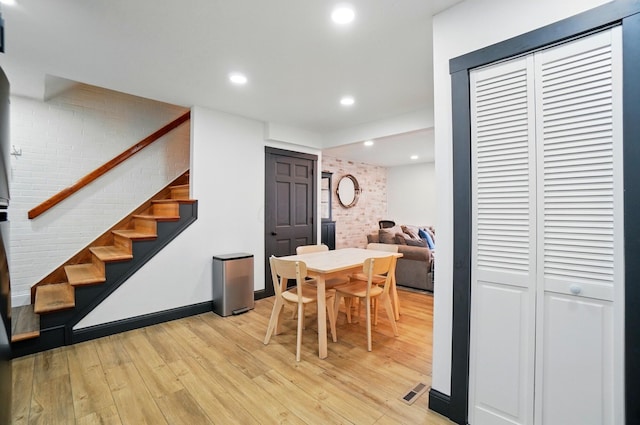 538 S Otterbein Ave Unit 2E, Westerville, OH 43081 - dining area featuring light wood-style flooring, stairway, brick wall, and recessed lighting