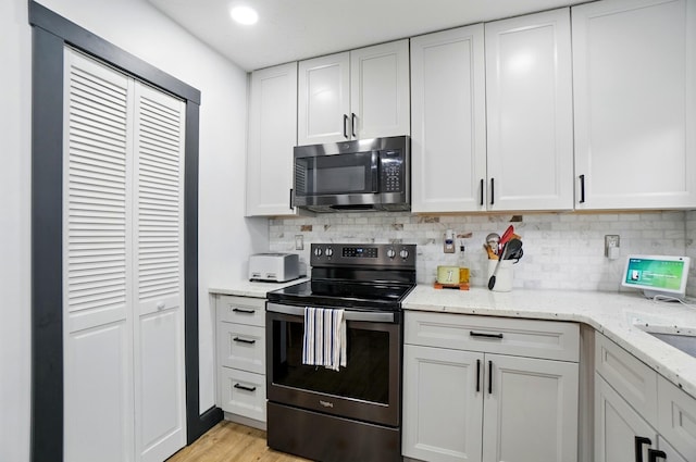 538 S Otterbein Ave Unit 2E, Westerville, OH 43081 - kitchen with stainless steel appliances, backsplash, white cabinetry, and recessed lighting