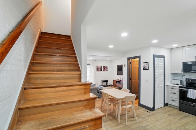 538 S Otterbein Ave Unit 2E, Westerville, OH 43081 - stairway featuring wood finished floors, recessed lighting, and baseboards