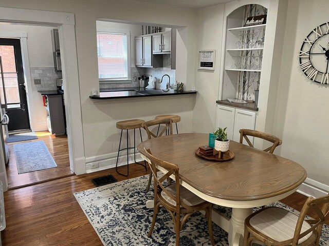 323 E Kossuth St, Columbus, OH 43206 - dining area featuring dark wood finished floors and baseboards
