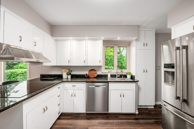 2105 Chardon Rd, Columbus, OH 43220 - kitchen with stainless steel appliances, under cabinet range hood, a sink, dark wood-style flooring, and white cabinetry