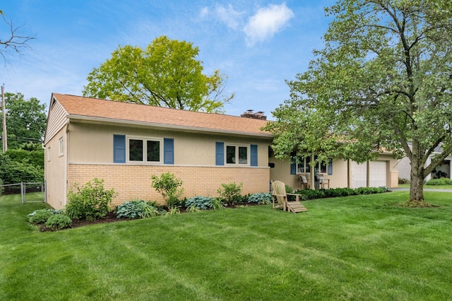 2105 Chardon Rd, Columbus, OH 43220 - view of front of house with brick siding, a garage, and a chimney