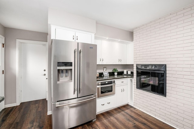 2105 Chardon Rd, Columbus, OH 43220 - kitchen featuring stainless steel appliances, dark wood-style flooring, dark countertops, and white cabinetry