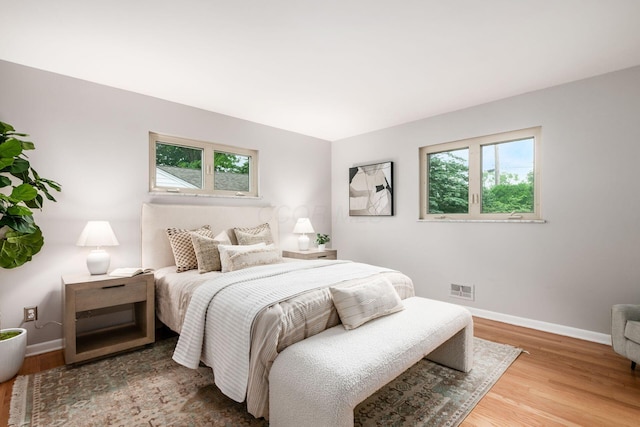 2105 Chardon Rd, Columbus, OH 43220 - bedroom with multiple windows, wood finished floors, and baseboards