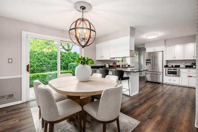 2105 Chardon Rd, Columbus, OH 43220 - dining area featuring a chandelier, dark wood-style flooring, and baseboards