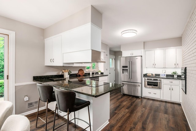 2105 Chardon Rd, Columbus, OH 43220 - kitchen with stainless steel appliances, a peninsula, healthy amount of natural light, and white cabinets