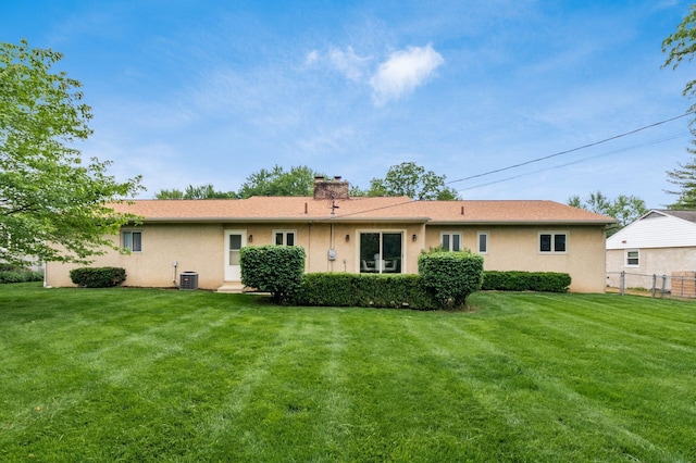 2105 Chardon Rd, Columbus, OH 43220 - back of house featuring a chimney, central AC, and stucco siding