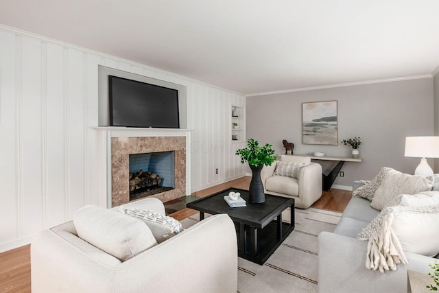 2105 Chardon Rd, Columbus, OH 43220 - living room with ornamental molding, light wood-style flooring, a high end fireplace, and baseboards