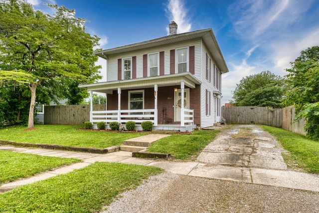 216 N St, Utica, OH 43080 - american foursquare style home featuring a porch, concrete driveway, and a chimney