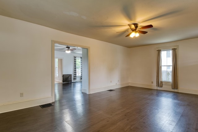 216 N St, Utica, OH 43080 - unfurnished room featuring ceiling fan, dark wood-style floors, and baseboards