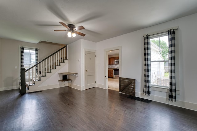 216 N St, Utica, OH 43080 - unfurnished living room with wood finished floors, a ceiling fan, stairs, and baseboards