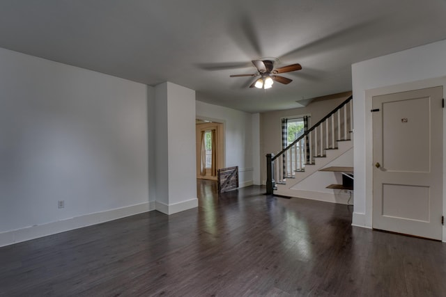 216 N St, Utica, OH 43080 - unfurnished living room featuring ceiling fan, wood finished floors, stairway, and baseboards