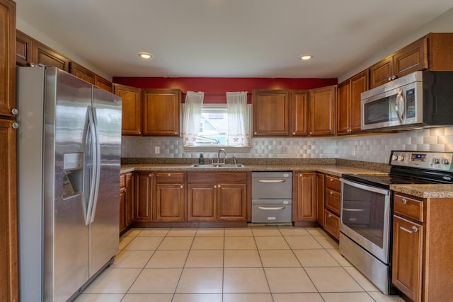 216 N St, Utica, OH 43080 - kitchen featuring stainless steel appliances, a sink, brown cabinetry, backsplash, and recessed lighting