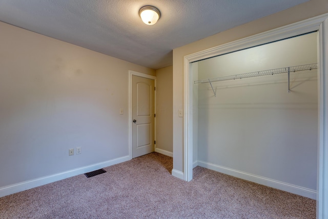 216 N St, Utica, OH 43080 - unfurnished bedroom featuring a closet, carpet floors, baseboards, and a textured ceiling