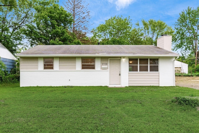 1516 Burlington Ave, Columbus, OH 43227 - view of front of home featuring a chimney, a front yard, and brick siding