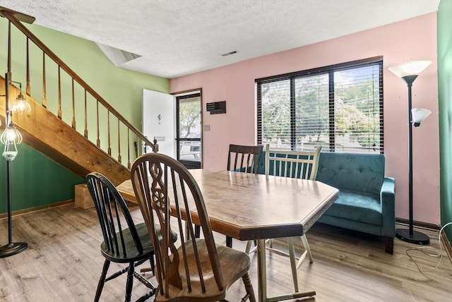 5722 Jousting Ln Unit B, Columbus, OH 43231 - dining room with wood finished floors, a textured ceiling, stairway, and baseboards