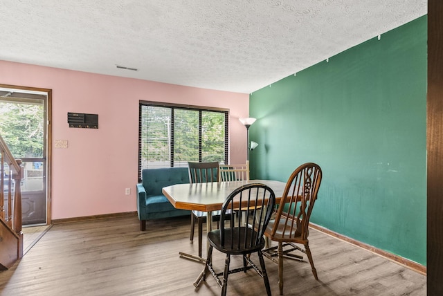 5722 Jousting Ln Unit B, Columbus, OH 43231 - dining room featuring wood finished floors, a textured ceiling, and baseboards
