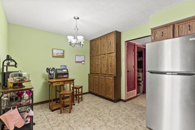5722 Jousting Ln Unit B, Columbus, OH 43231 - dining area with a chandelier, baseboards, light tile patterned floors, and a textured ceiling