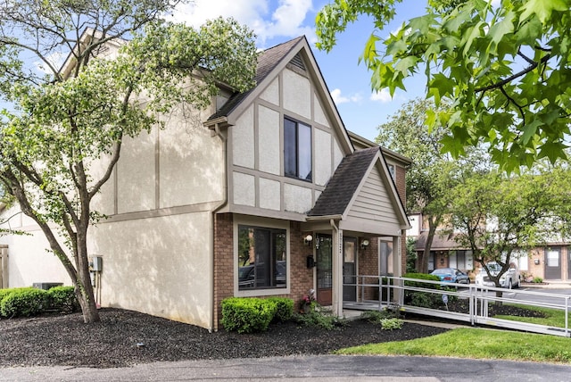 5722 Jousting Ln Unit B, Columbus, OH 43231 - tudor house with stucco siding, brick siding, and a shingled roof