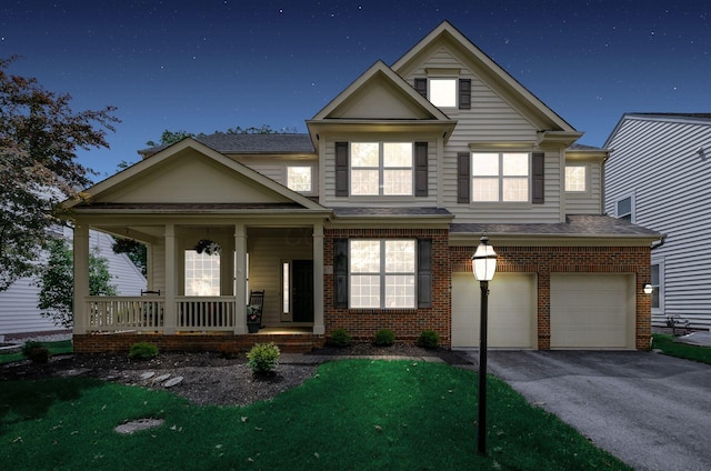 5673 Sugarwood Dr, New Albany, OH 43054 - traditional home with a porch, a garage, brick siding, asphalt driveway, and roof with shingles