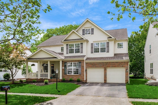 5673 Sugarwood Dr, New Albany, OH 43054 - view of front of home featuring a porch, asphalt driveway, a shingled roof, an attached garage, and a front yard