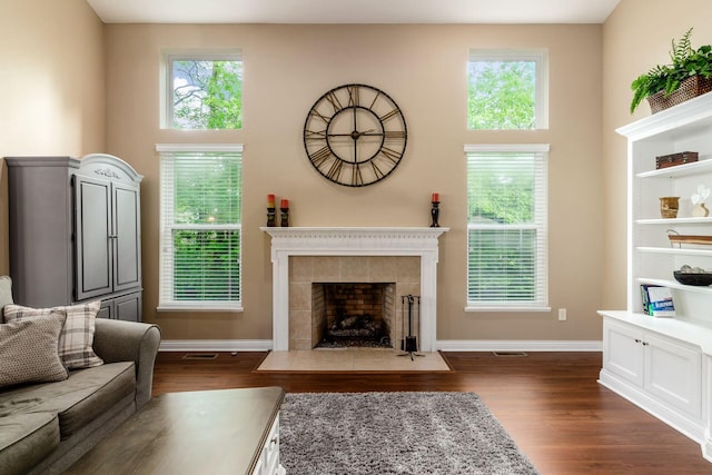 5673 Sugarwood Dr, New Albany, OH 43054 - living area featuring dark wood finished floors, baseboards, and a fireplace