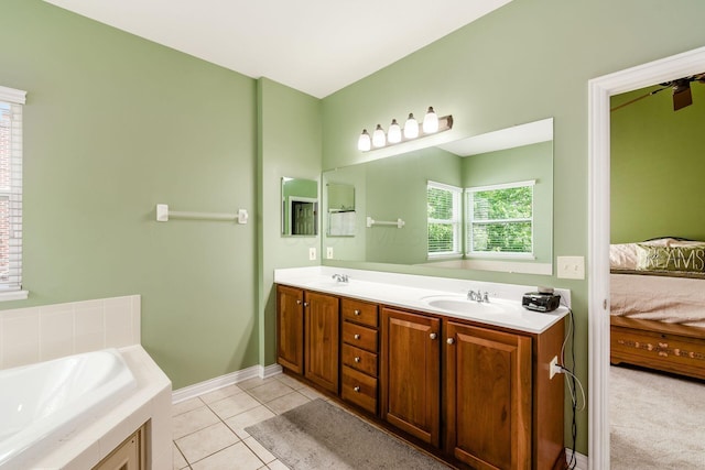 5673 Sugarwood Dr, New Albany, OH 43054 - ensuite bathroom with double vanity, a bath, tile patterned flooring, and baseboards