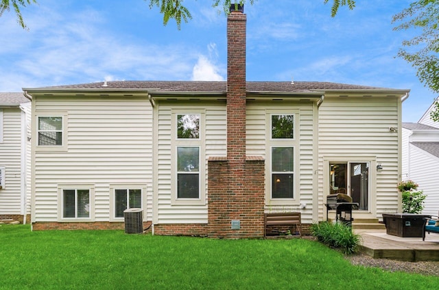 5673 Sugarwood Dr, New Albany, OH 43054 - rear view of property with a lawn, a patio, central AC unit, a chimney, and roof with shingles