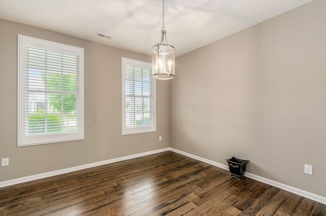 7839 Eastcross Dr, New Albany, OH 43054 - unfurnished room with dark wood-type flooring, baseboards, and a chandelier