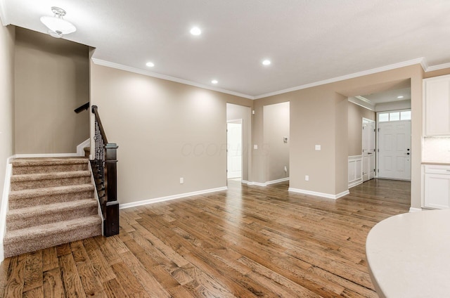 7839 Eastcross Dr, New Albany, OH 43054 - unfurnished living room with light wood-style floors, ornamental molding, recessed lighting, stairs, and baseboards