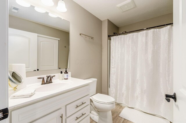 7839 Eastcross Dr, New Albany, OH 43054 - bathroom with toilet, vanity, wood finished floors, and a shower with shower curtain