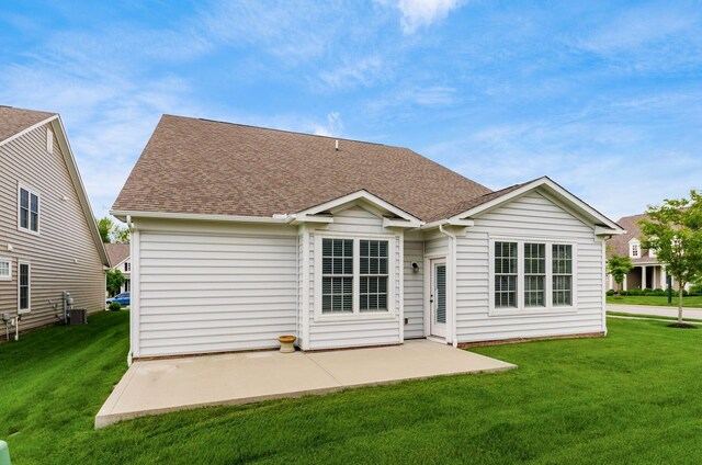7839 Eastcross Dr, New Albany, OH 43054 - rear view of property featuring a lawn, a patio area, roof with shingles, and central AC unit