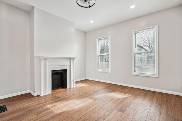 1598 Harvard Ave, Columbus, OH 43203 - unfurnished living room with wood-type flooring, baseboards, a fireplace, and recessed lighting
