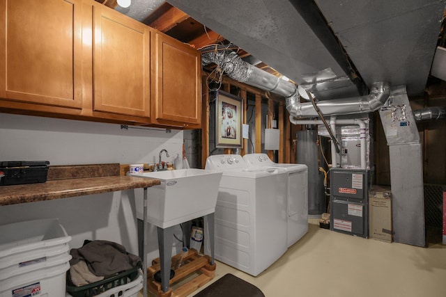 883 Mcnaughten Rd, Columbus, OH 43213 - laundry room featuring cabinet space, washing machine and clothes dryer, and water heater