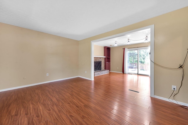 883 Mcnaughten Rd, Columbus, OH 43213 - unfurnished living room with wood finished floors and a fireplace
