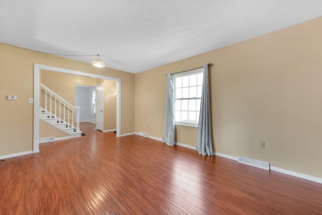 883 Mcnaughten Rd, Columbus, OH 43213 - spare room with wood finished floors and stairway