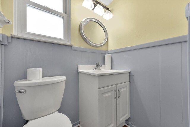 883 Mcnaughten Rd, Columbus, OH 43213 - bathroom featuring vanity, a wainscoted wall, and a decorative wall