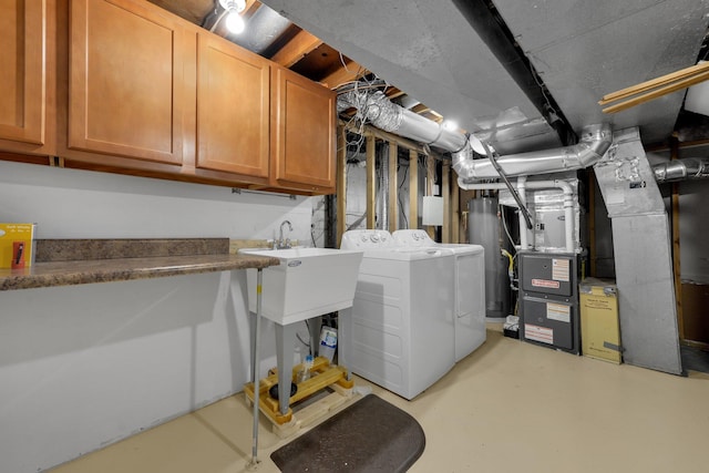 883 Mcnaughten Rd, Columbus, OH 43213 - washroom with separate washer and dryer, cabinet space, water heater, and heating unit