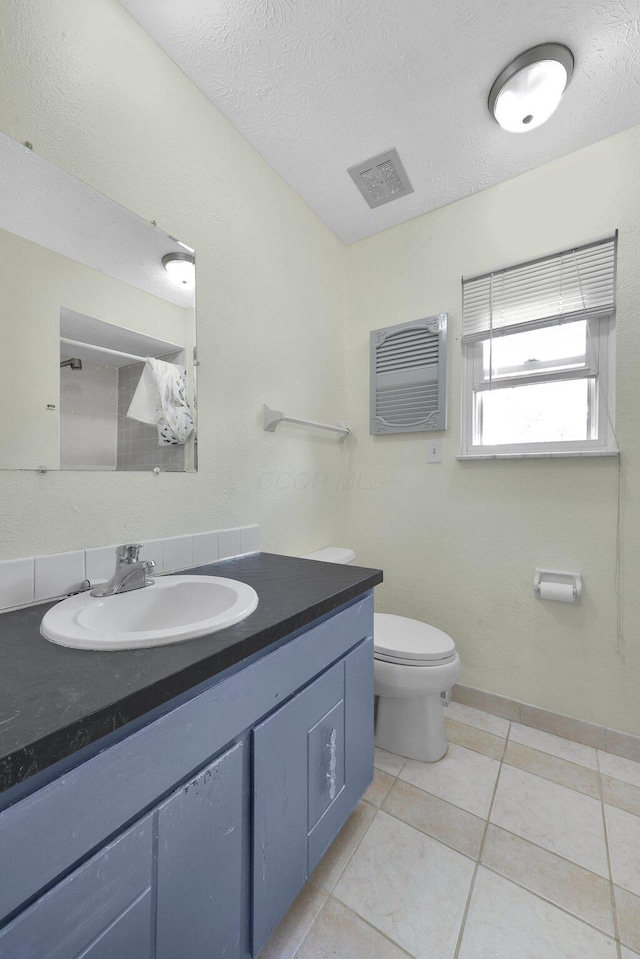 883 Mcnaughten Rd, Columbus, OH 43213 - bathroom featuring vanity, a textured ceiling, and tile patterned floors