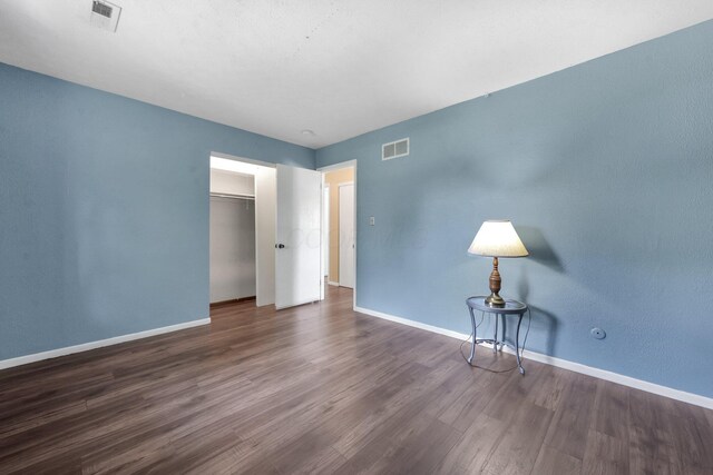 883 Mcnaughten Rd, Columbus, OH 43213 - unfurnished bedroom featuring dark wood-type flooring and a closet