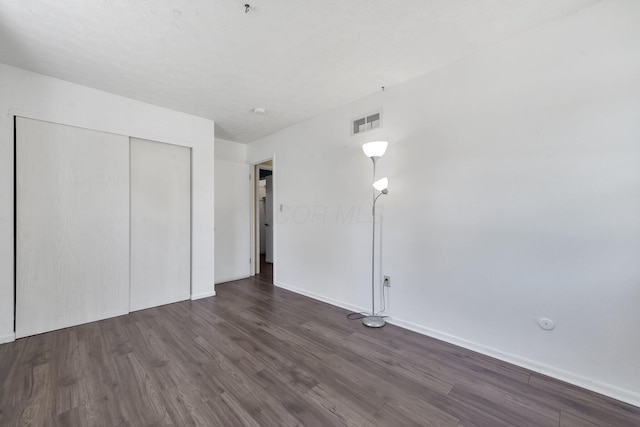 883 Mcnaughten Rd, Columbus, OH 43213 - unfurnished bedroom with dark wood-type flooring and a closet