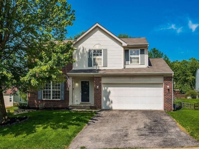 263 Timber Hearth Ct, Newark, OH 43055 - traditional home with asphalt driveway, a front yard, brick siding, and an attached garage