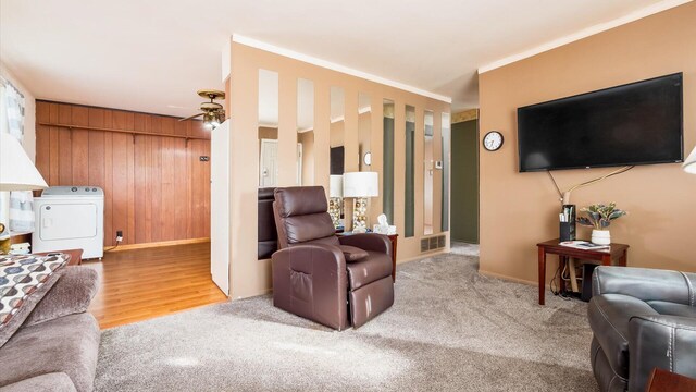 524 Ridgefield Rd, Newark, OH 43055 - carpeted living room featuring washer / dryer, ceiling fan, baseboards, wood walls, and ornamental molding