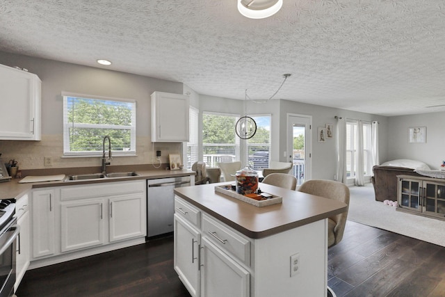 226 Purple Finch Loop, Pataskala, OH 43062 - kitchen featuring appliances with stainless steel finishes, a sink, open floor plan, dark wood-style floors, and white cabinetry