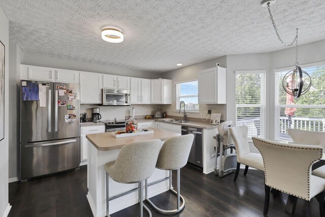 226 Purple Finch Loop, Pataskala, OH 43062 - kitchen featuring stainless steel appliances, a sink, dark wood-style floors, white cabinets, and a textured ceiling